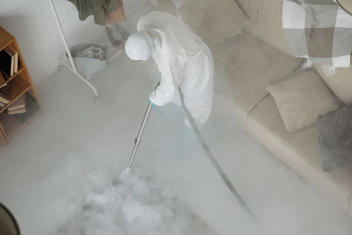 Biohazard cleanup technician in protective equipment, Haight Ashbury, San Francisco, CA